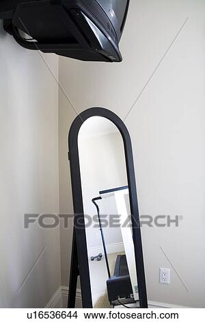 Full length mirror and television in corner of room View Large Photo Image Picture - Full length mirror and television in corner of room. Fotosearch