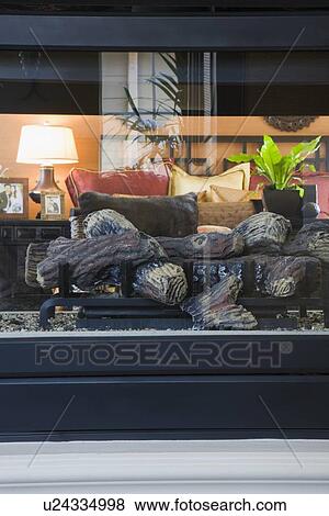 Stock Photo - Gas fireplace in center of room. Fotosearch