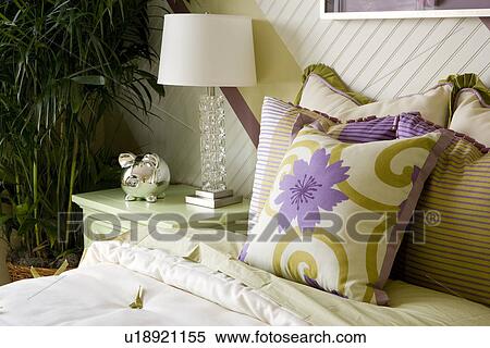 Green and purple pillows on bed next to green night stand View Large Photo Image Stock Photography - Green and purple pillows on bed next to green night stand. Fotosearch