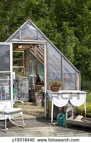Stock Image - green house in country garden. Fotosearch