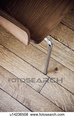 High angle wooden chair detail on hardwood floor View Large Photo Image Stock Photo - High angle wooden chair detail on hardwood floor. Fotosearch