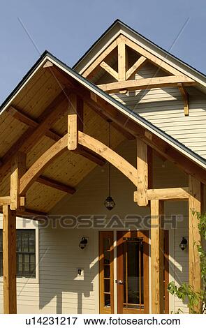 Home front entrance with wooden overhang View Large Photo Image Stock Photo - Home front entrance with wooden overhang. Fotosearch