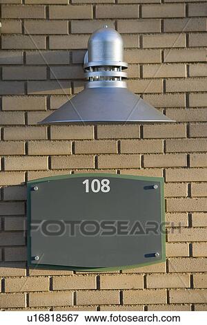 Stock Photo - industrial style exterior wall light on brick wall. Fotosearch