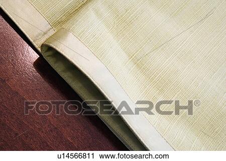 Stock Image - Light green placemat on dining table. Fotosearch