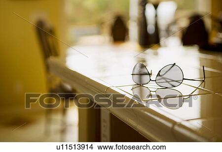 Pair of aviator sunglasses on tile kitchen counter View Large Photo Image Picture - Pair of aviator sunglasses on tile kitchen counter. Fotosearch