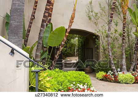 Pathway through arch with landscaping View Large Photo Image Stock Image - Pathway through arch with landscaping. Fotosearch