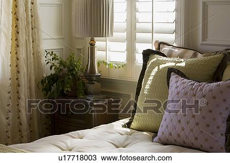 Purple and green decorative pillows on bed near window View Large Photo Image Stock Image - Purple and green decorative pillows on bed near window. Fotosearch