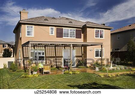 Stock Photo - Rear exterior multiple story home. Fotosearch