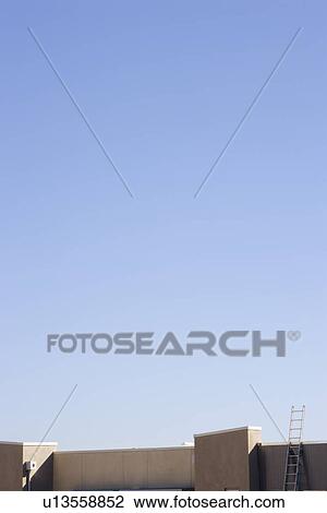 Stock Image - Roofline of Building with Ladder. Fotosearch