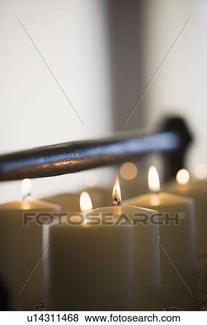 Stock Photo - Rows of lit candles centerpiece. Fotosearch