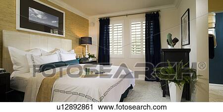 Stock Image - Serene Bedroom with Blue Accents, panoramic. Fotosearch