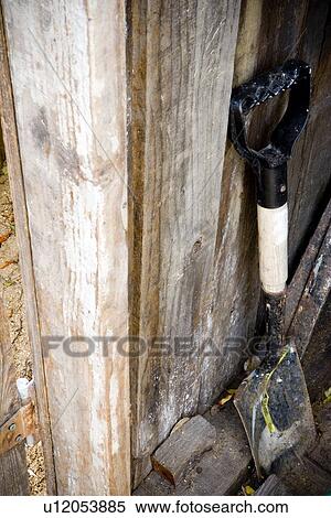 Shovel leaning against wooden fence View Large Photo Image Stock Photography - Shovel leaning against wooden fence. Fotosearch