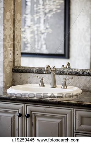 Stock Photography - Simple bathroom sink and mirror. Fotosearch