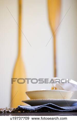 Simple place setting with wooden oars on wall View Large Photo Image Stock Photo - Simple place setting with wooden oars on wall. Fotosearch