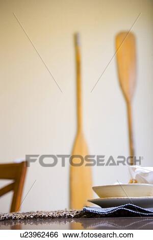 Simple place setting with wooden oars on wall View Large Photo Image Stock Photograph - Simple place setting with wooden oars on wall. Fotosearch