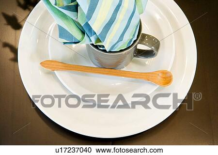 Stock Image - Simple place setting with wooden spoon. Fotosearch