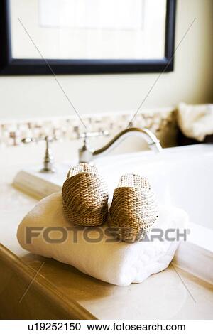 Slippers on folded towel near bathtub View Large Photo Image Stock Image - Slippers on folded towel near bathtub. Fotosearch