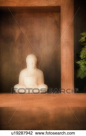 Small statue on wooden shelf View Large Photo Image Stock Image - Small statue on wooden shelf. Fotosearch