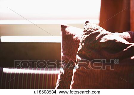 Sunlight on red throw pillows View Large Photo Image Picture - Sunlight on red throw pillows. Fotosearch