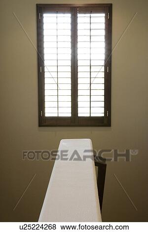Stock Photo - Symmetrical view above staircase wall to window. Fotosearch
