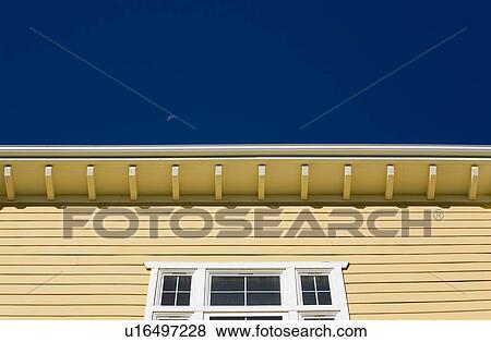 Symmetrical view of yellow building against blue sky View Large Photo Image Stock Photo - Symmetrical view of yellow building against blue sky. Fotosearch