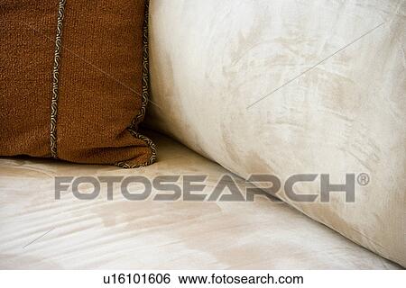 Throw pillow on suede sofa View Large Photo Image Stock Photograph - Throw pillow on suede sofa. Fotosearch
