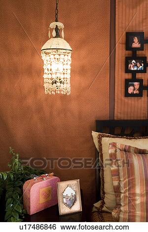 Throw pillows and hanging light in bedroom View Large Photo Image Stock Photograph - Throw pillows and hanging light in bedroom. Fotosearch