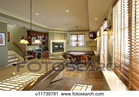 Stock Image - Traditional game room with pool and poker table. Fotosearch