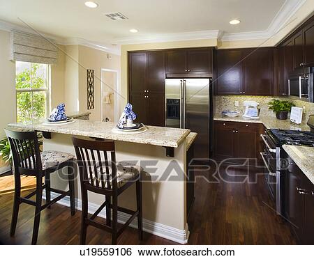 Traditional kitchen with breakfast bar and dark wood cabinets View Large Photo Image Stock Photograph - Traditional kitchen with breakfast bar and dark wood cabinets. Fotosearch