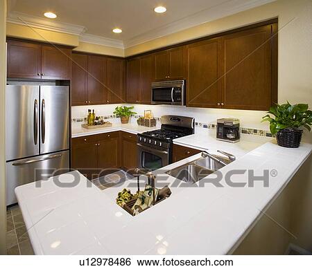 Traditional kitchen with wooden cabinets and crown molding View Large Photo Image Stock Photograph - Traditional kitchen with wooden cabinets and crown molding. Fotosearch