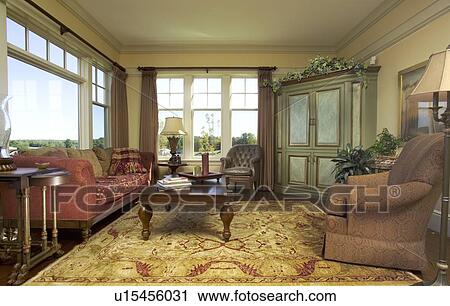 Stock Image - Traditional living room with area rug and picture window. Fotosearch