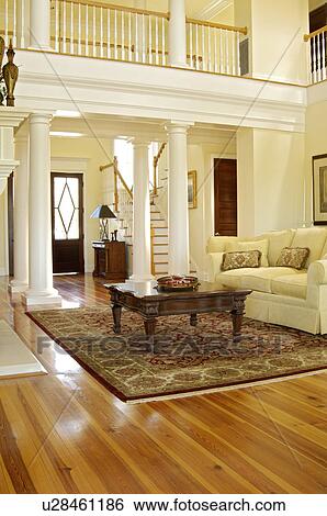 Traditional living room with support columns and loft with railing View Large Photo Image Stock Photograph - Traditional living room with support columns and loft with railing. Fotosearch