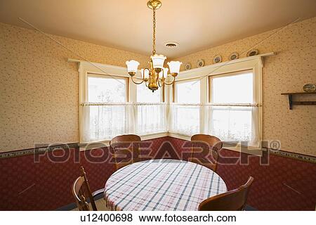 Stock Photo - traditional round table in corner by window. Fotosearch