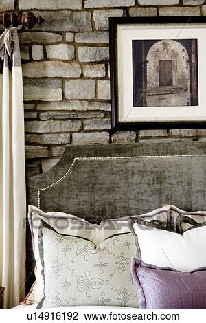 Stock Image - Velvet headboard in front of stone wall. Fotosearch