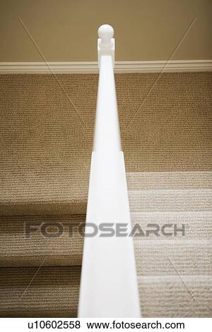 Stock Photo - View down railing of U Shaped staircase. Fotosearch