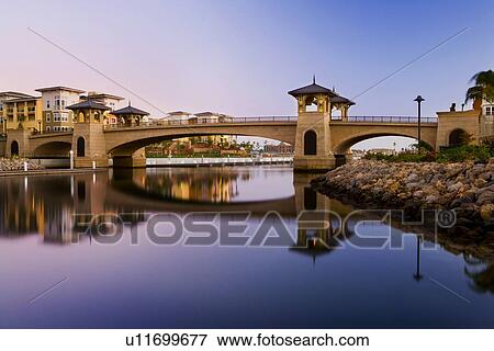 Stock Photo - View of bridge with towers across channel. Fotosearch