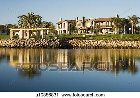 Stock Image - View of contemporary housing community from across channel. Fotosearch