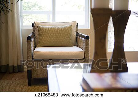 View of wicker armchair behind coffee table with candlesticks View Large Photo Image Stock Image - View of wicker armchair behind coffee table with candlesticks. Fotosearch