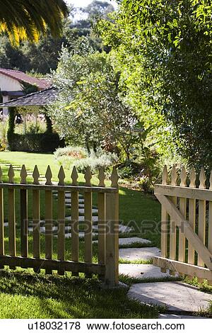 Stock Photo - White picket fence with gate over stone walkway. Fotosearch