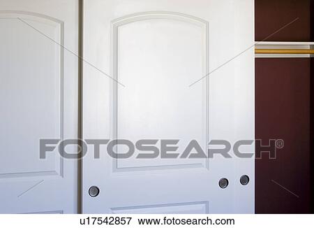 Stock Photo - White sliding closet doors. Fotosearch