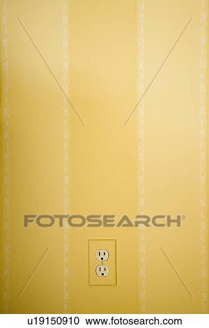 Stock Image - Yellow striped wall with electrical outlet. Fotosearch