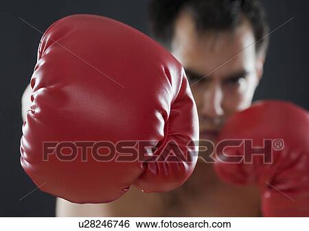 Stock Photograph - A boxer throwing punches. Fotosearch