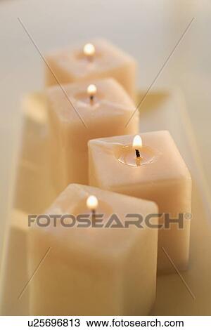 Stock Image - A group of lighted candles. Fotosearch