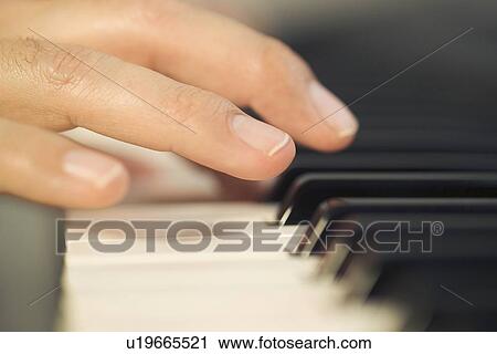 Stock Image - A man playing the piano. Fotosearch
