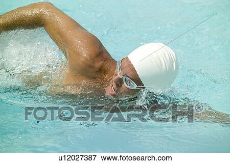 Stock Photo - A man swimming in a pool. Fotosearch