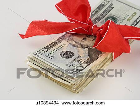Picture - A stack of money with a bow. Fotosearch