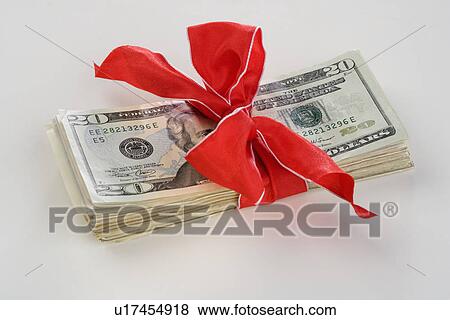 Stock Photo - A stack of money with a bow. Fotosearch