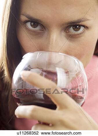 A woman sipping red wine View Large Photo Image Stock Image - A woman sipping red wine. Fotosearch