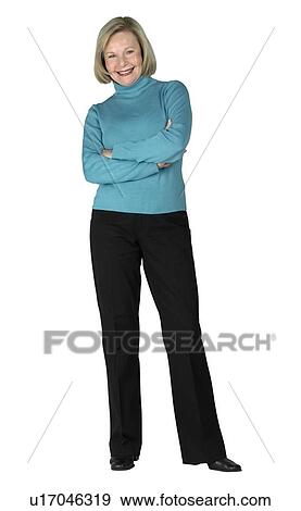 A woman standing with her arms folded View Large Photo Image Stock Photo - A woman standing with her arms folded. Fotosearch
