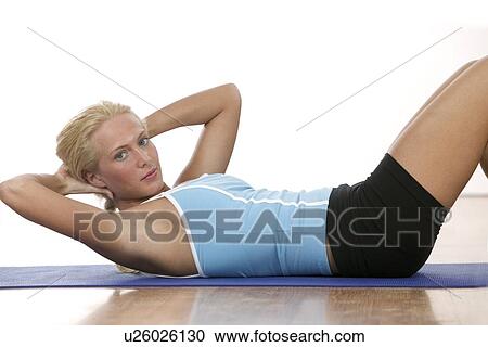 A young woman working out View Large Photo Image Stock Image - A young woman working out. Fotosearch